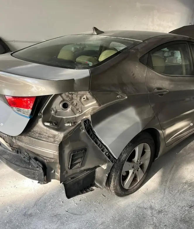 Hyundai Elantra quarter panel damage before body repair at CT Collision in Kissimmee, Florida